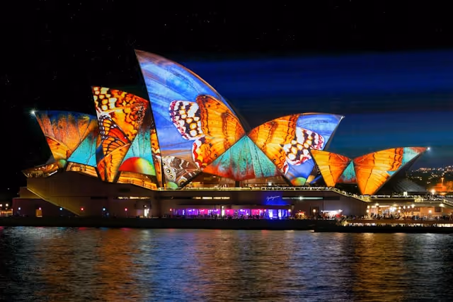 The Sydney Opera House illuminated with vibrant butterfly-themed projections during Vivid Sydney.
