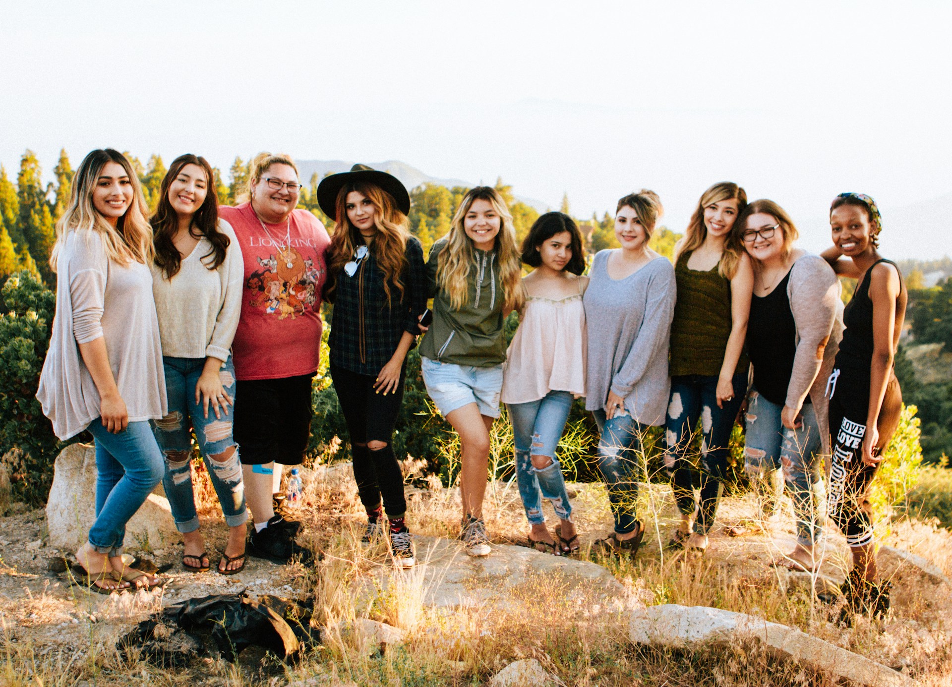 Group of women smiling together outdoors during a girls’ weekend, capturing the fun and connection of a shared getaway.