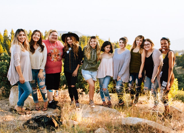 Group of women smiling together outdoors during a girls’ weekend, capturing the fun and connection of a shared getaway.