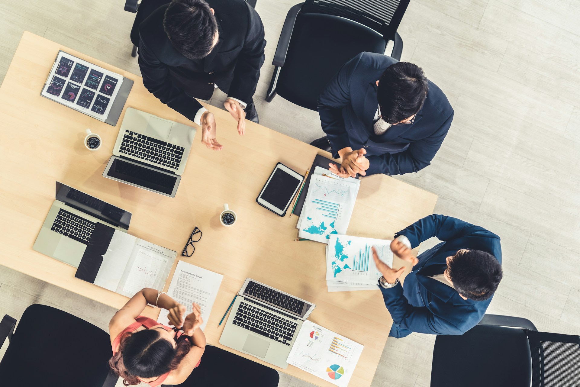 Business professionals in a meeting, representing corporate schedules, event coordination and chauffeur wait time management for executive travel.