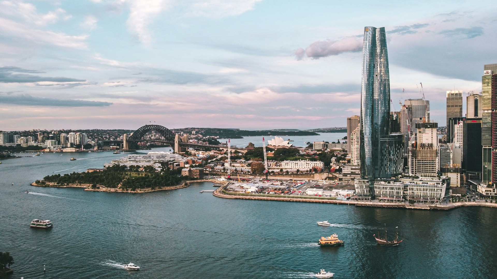 Aerial view of Sydney Harbour featuring Barangaroo, Sydney Harbour Bridge, Sydney Opera House and ferry traffic.