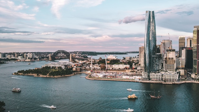 Aerial view of Sydney Harbour featuring Barangaroo, Sydney Harbour Bridge, Sydney Opera House and ferry traffic.