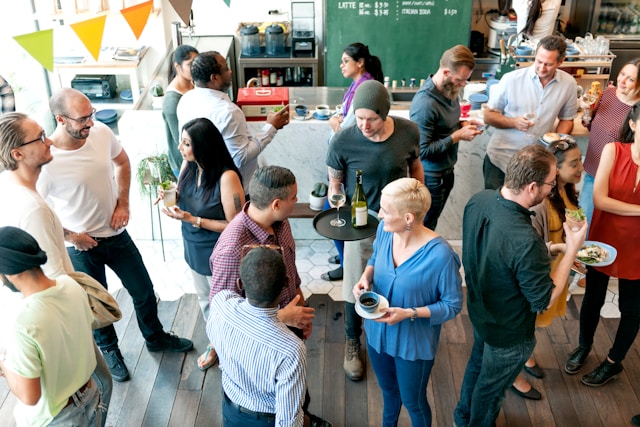 Colleagues mingling and chatting at a corporate offsite gathering.