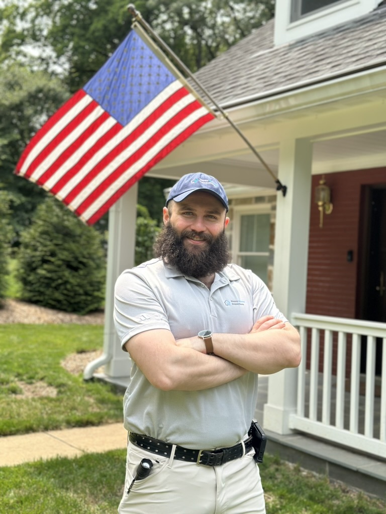 Jacob Ayhan the owner of Happy Homes Inspections crossing his arms in front of a residential home he just inspected in Northern Virginia.