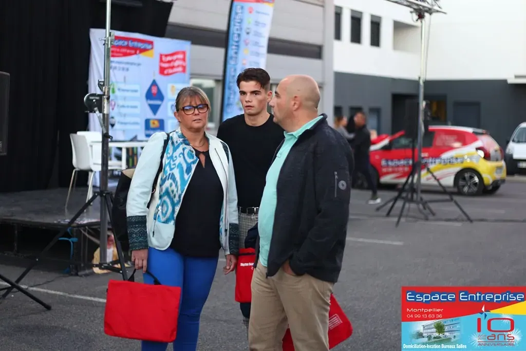 10 ans du centre Espace Entreprise Millénaire à Castelnau-le-Lez en 2018 : participants avec sacs rouges devant le bâtiment et le kakémono