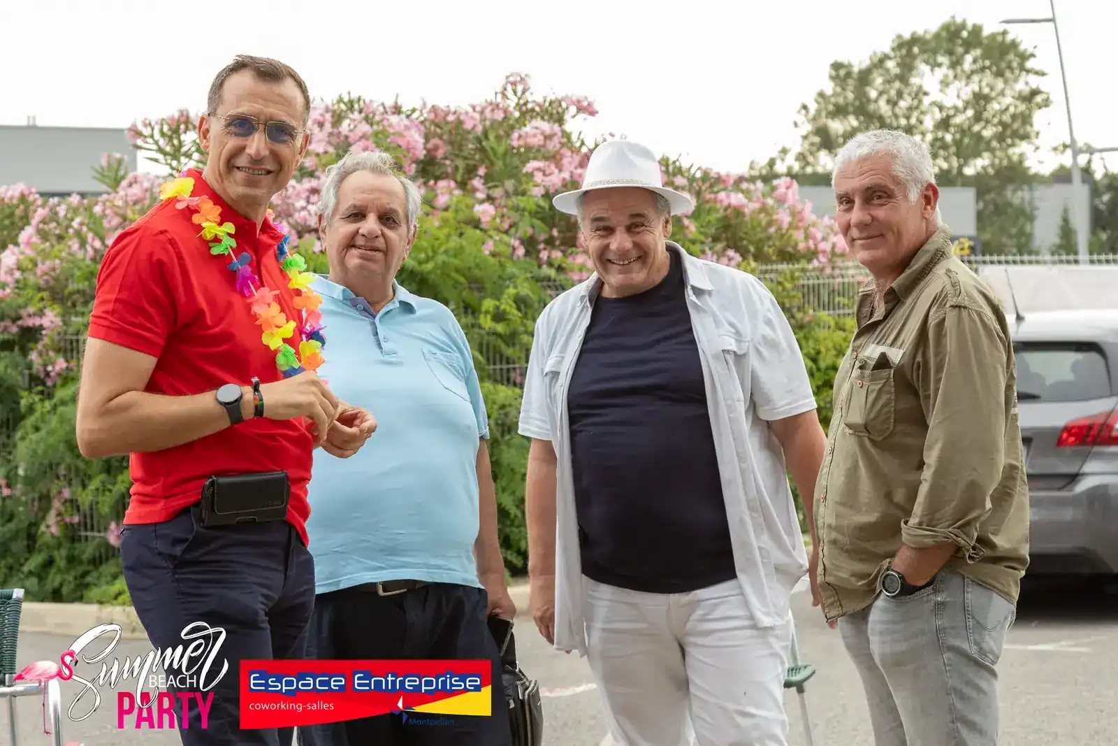 Summer Beach 2024 du Club LR à Montpellier : quatre hommes posant devant les lauriers-roses