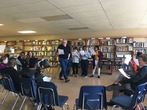 Nick Hutchison in a school room teaching students