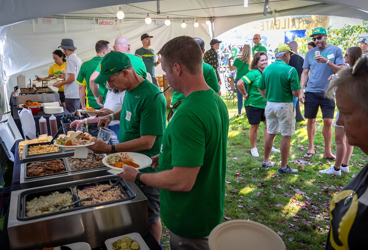 People serving themselves food at the event.
