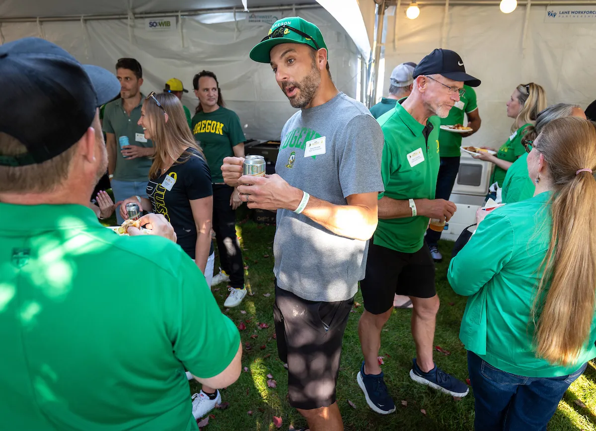 People engaged in lively conversation at the Tailgate event.