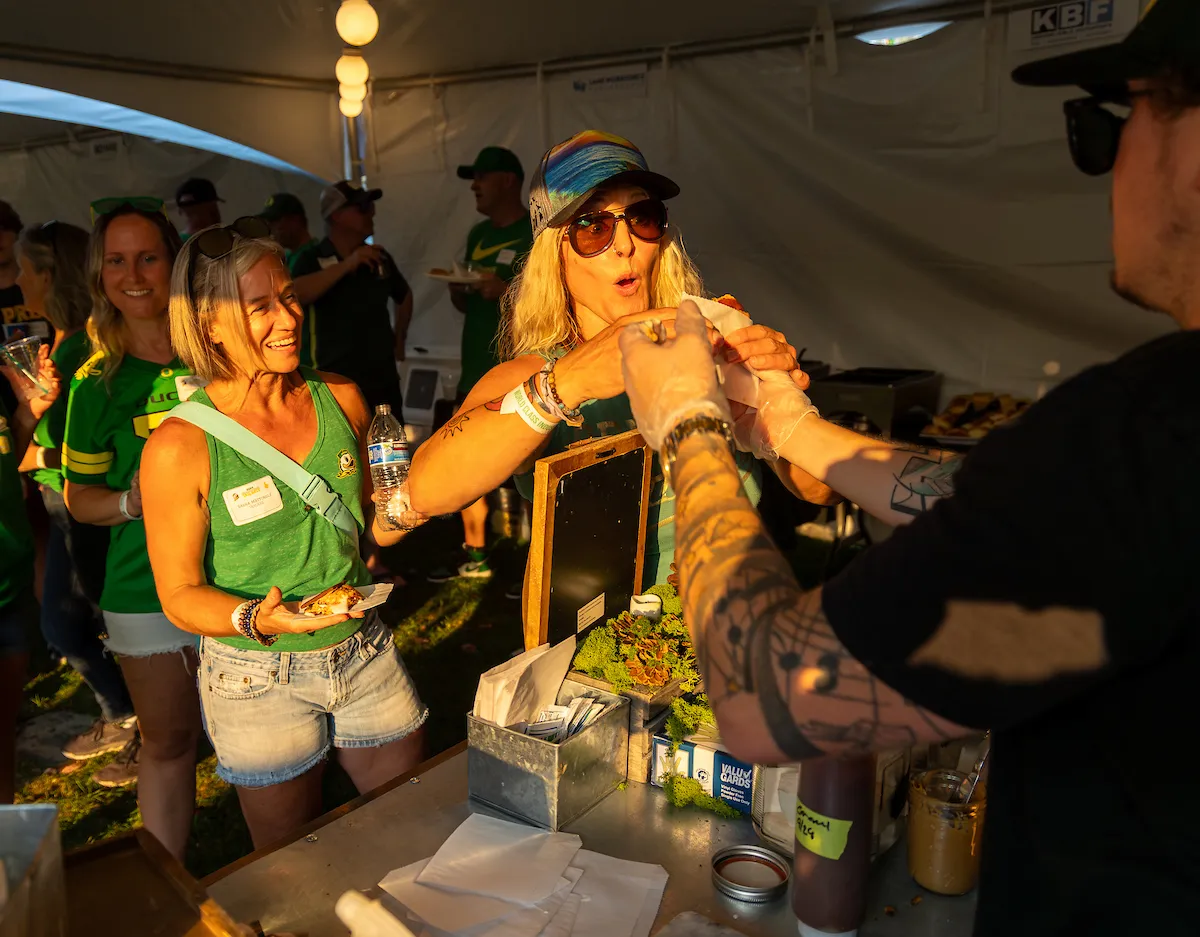 A food vendor serving food to attendees.