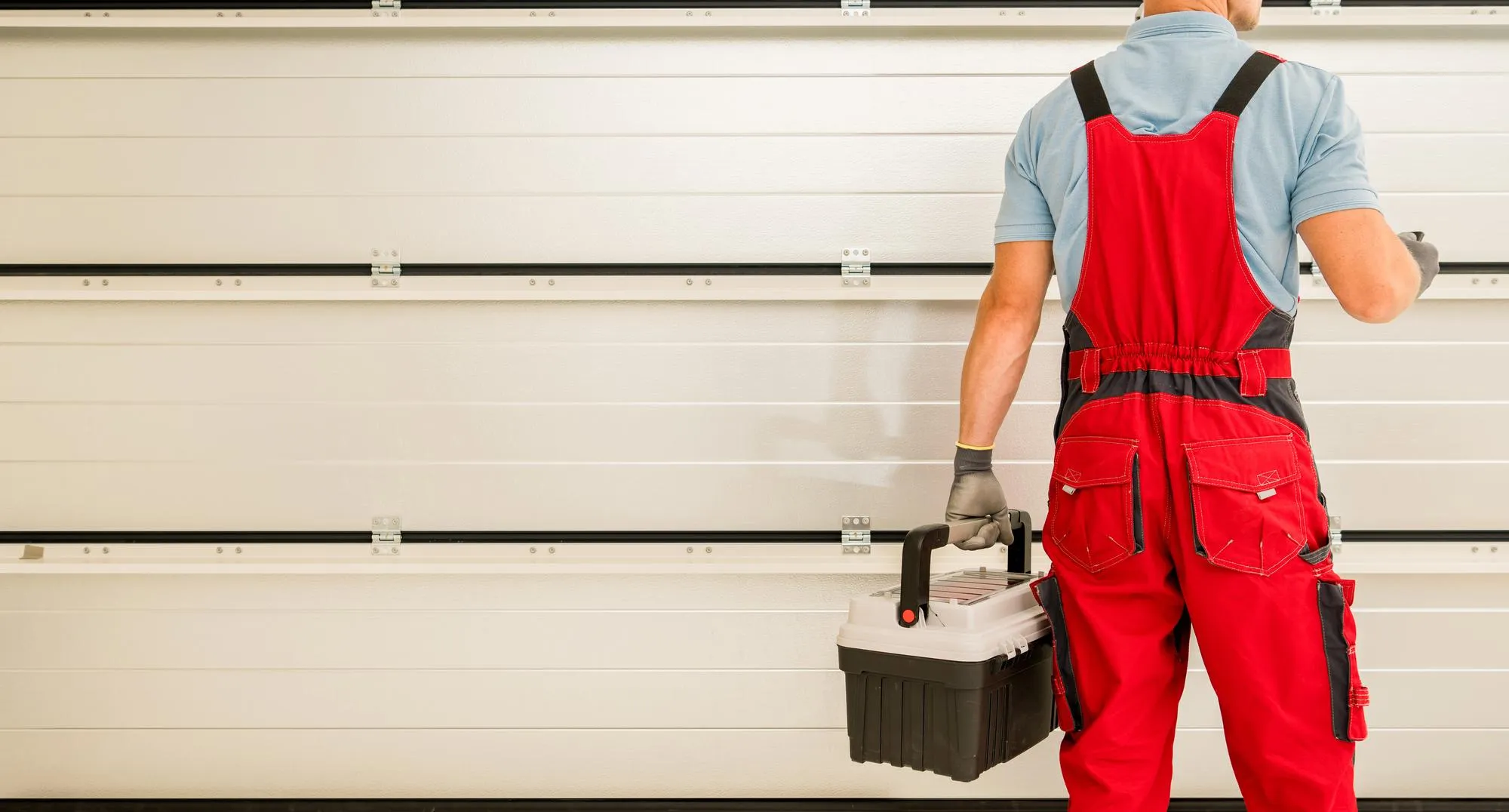 Complete Door Solutions – modern white garage door with vertical window panels for a stylish look.