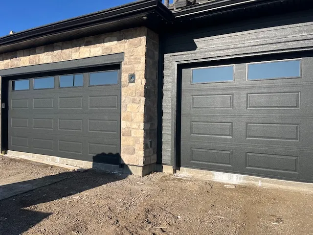 Complete Door Solutions – modern white garage door with vertical window panels for a stylish look.