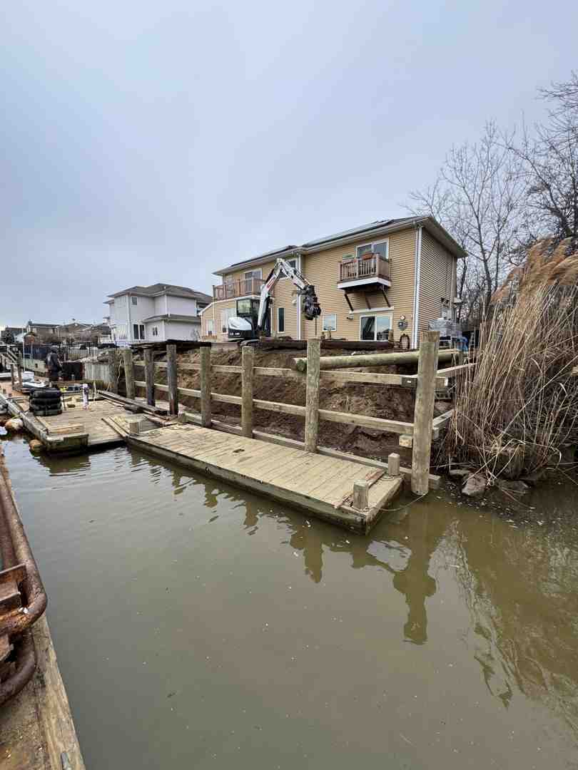 A marine contractor surveying a waterfront property with measurement tools, emphasizing the meticulous planning involved in dock construction - boat dock installation A marine contractor surveying a waterfront property with measurement tools, emphasizing the meticulous planning involved in dock construction - boat dock installation