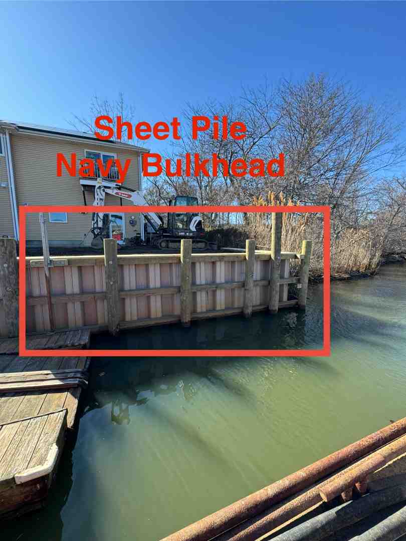 bulkhead effectively holding back soil on a calm bay in West Islip, NY - bulkhead walls