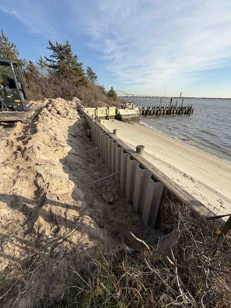 heavy machinery installing a vinyl bulkhead in Nassau County - Shoreline erosion control solutions heavy machinery installing a vinyl bulkhead in Nassau County - Shoreline erosion control solutions