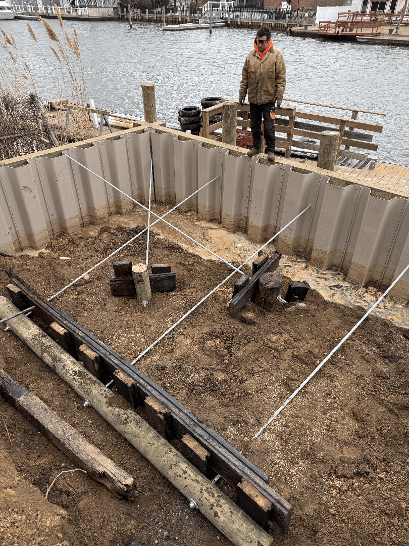 bulkhead construction in West Islip Long Island featuring vinyl sheet piling and heavy equipment - shoreline stabilization bulkhead construction in West Islip Long Island featuring vinyl sheet piling and heavy equipment - shoreline stabilization