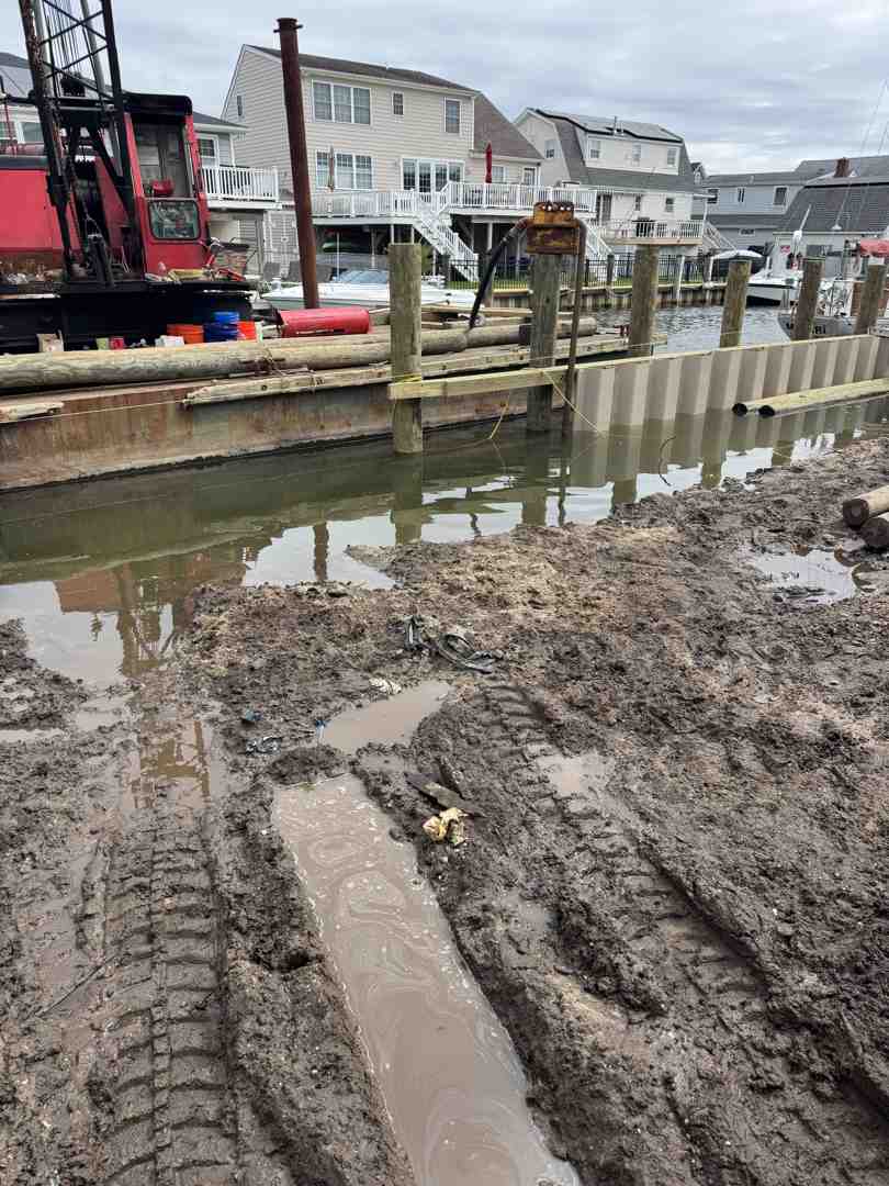 heavy-duty steel bulkhead under construction with deep-driven piles - storm surge protection