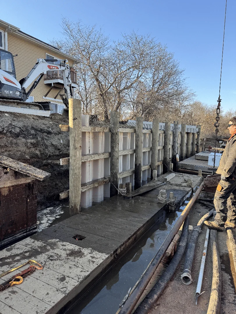 marine contractors installing pre-cast concrete panels in West Islip