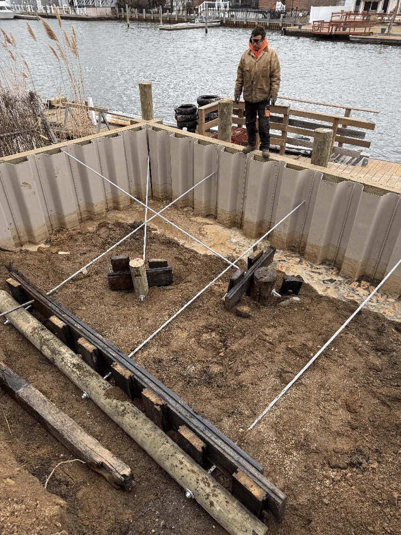 Marine construction crew repairing a boat slip bulkhead and replacing piles on Long Island