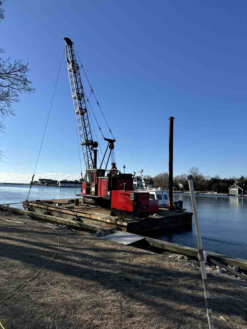 Marine crane barge positioning a heavy-duty boat lift on Long Island