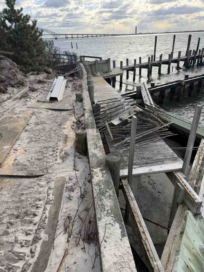 cracked concrete seawall cap showing spalling and exposed rebar on Long Island shoreline