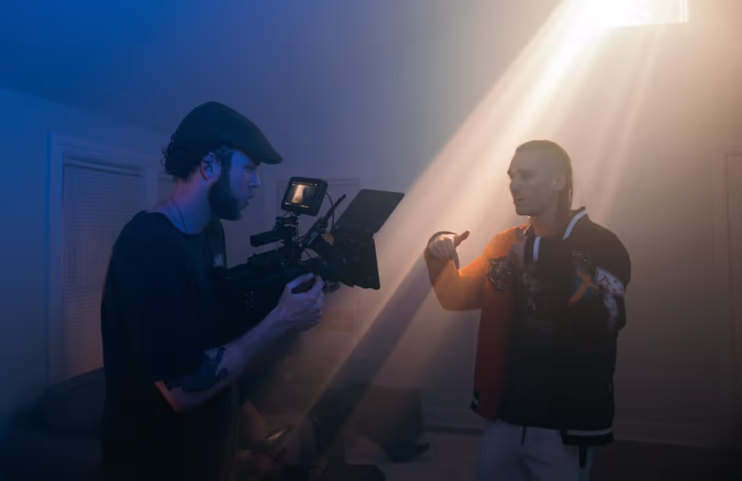 A couple of men standing next to each other in a room.
