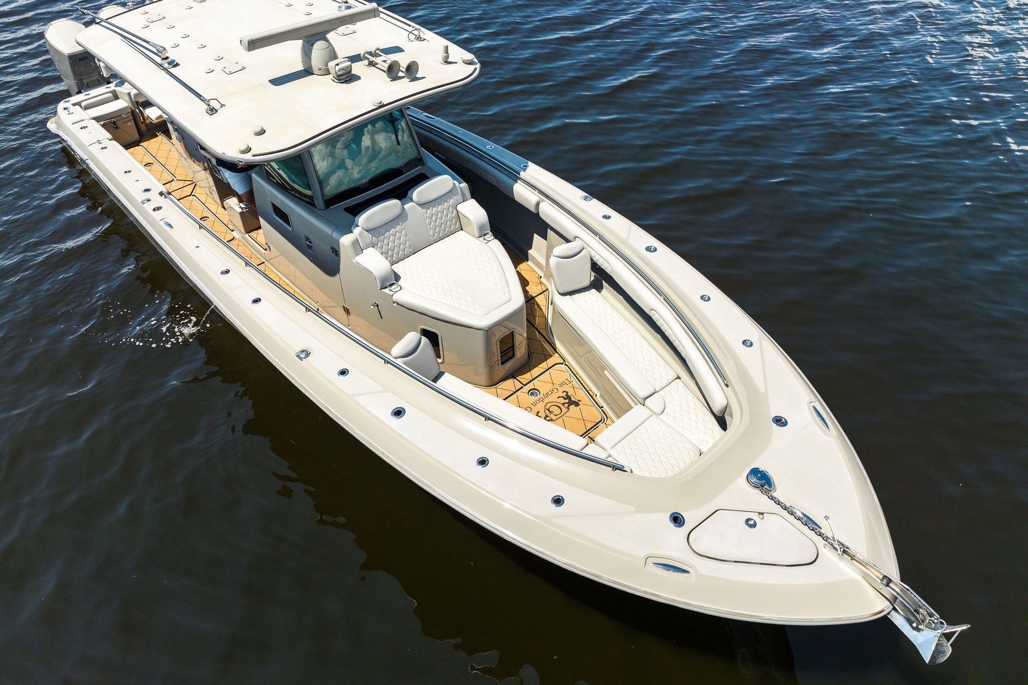 2023 HCB 42 Lujo luxury boat on calm water, showcasing sleek design and spacious deck.