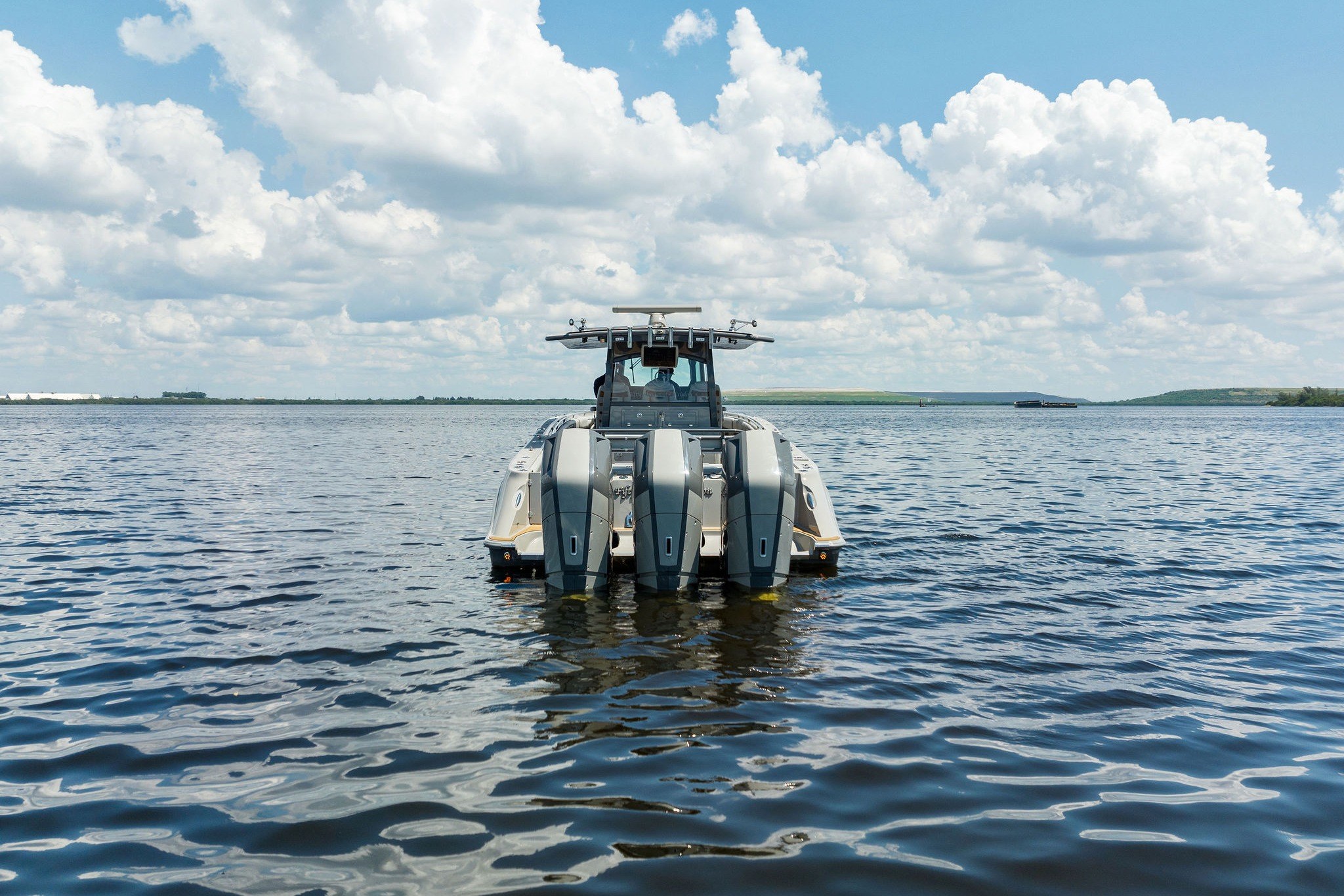 2023 HCB 42 Lujo boat on calm water under a cloudy sky.