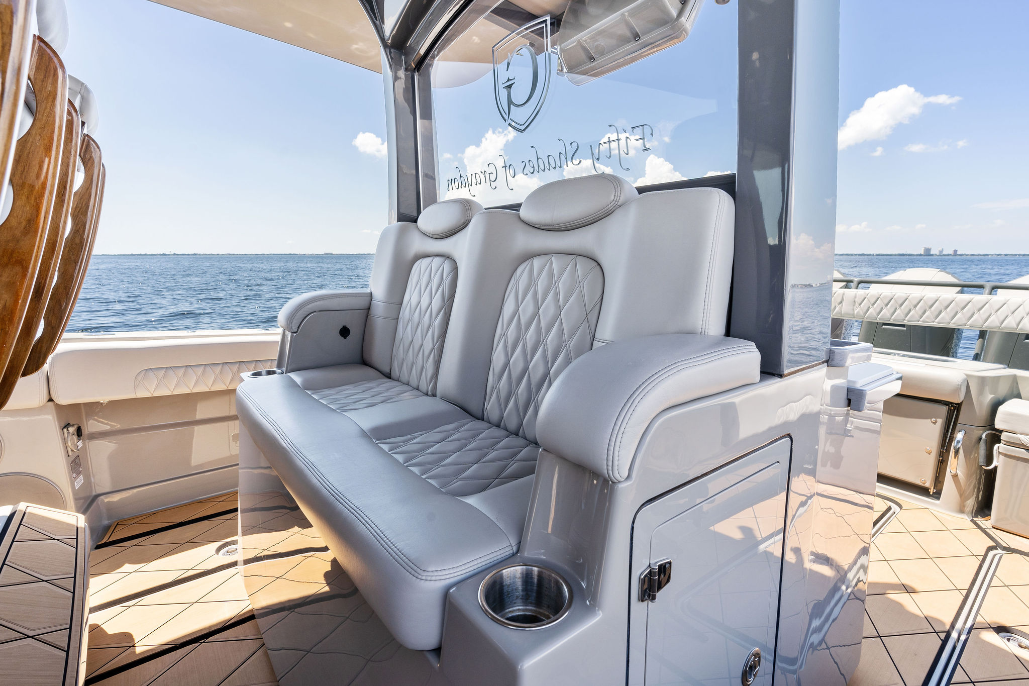 Luxurious seating on 2023 HCB 42 Lujo boat with ocean view.