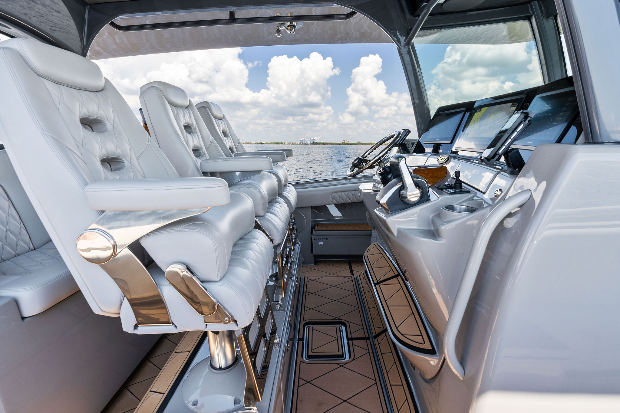 Luxurious interior of 2023 HCB 42 Lujo boat with plush seating and advanced controls.