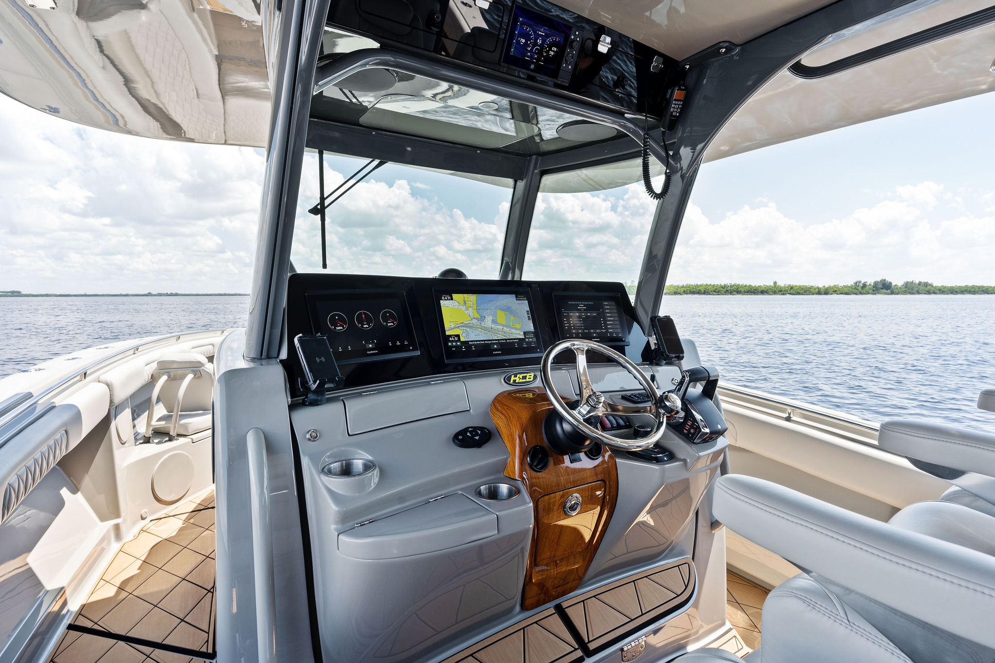 2023 HCB 42 Lujo boat helm with advanced navigation system on open water.