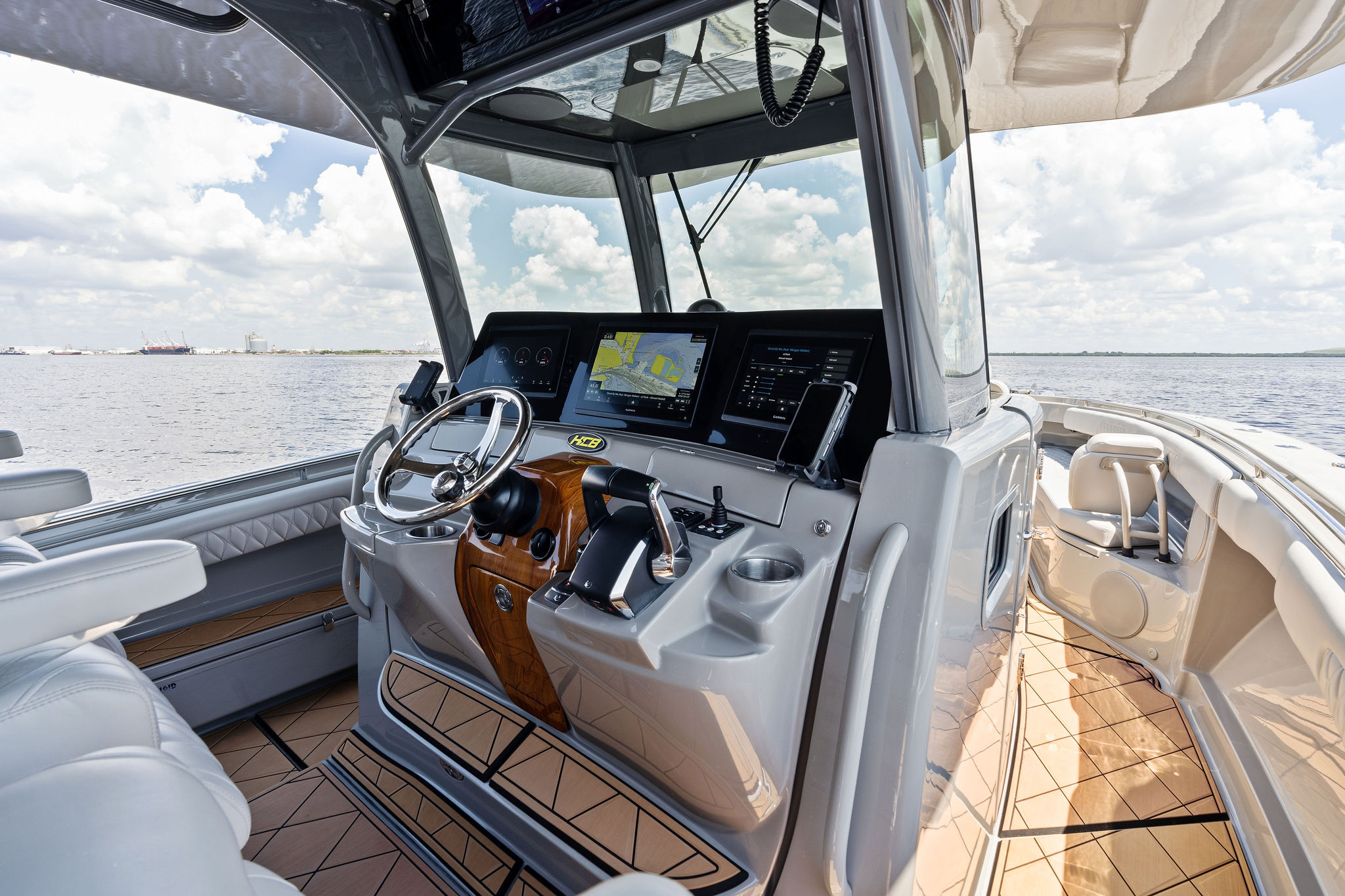 Helm of 2023 HCB 42 Lujo boat with modern controls and navigation screens.