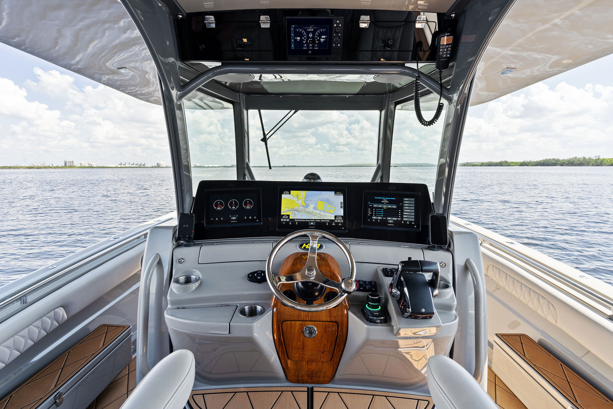 Helm of 2023 HCB 42 Lujo boat with advanced navigation systems on open water.