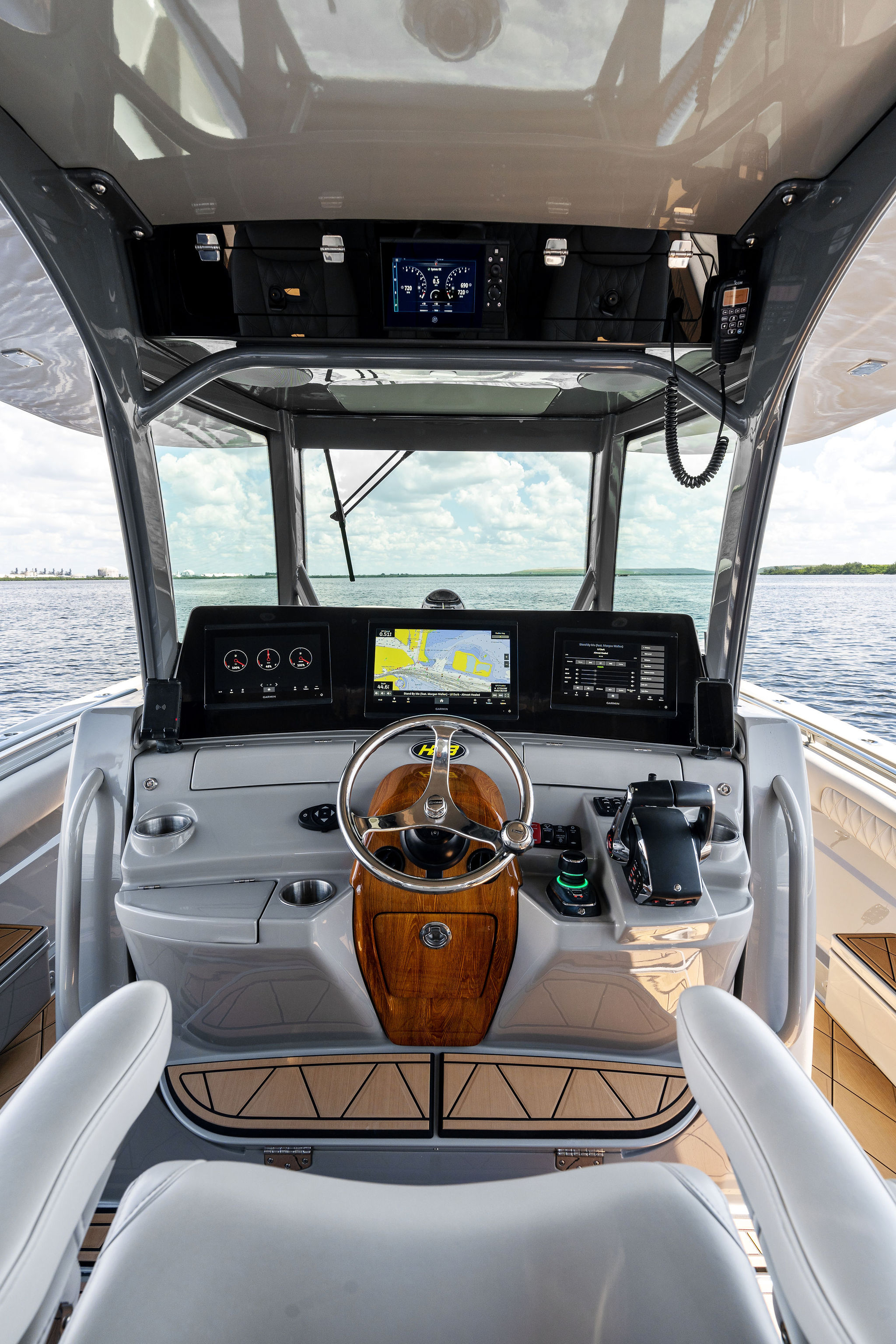 Helm of 2023 HCB 42 Lujo boat with advanced navigation displays and controls.