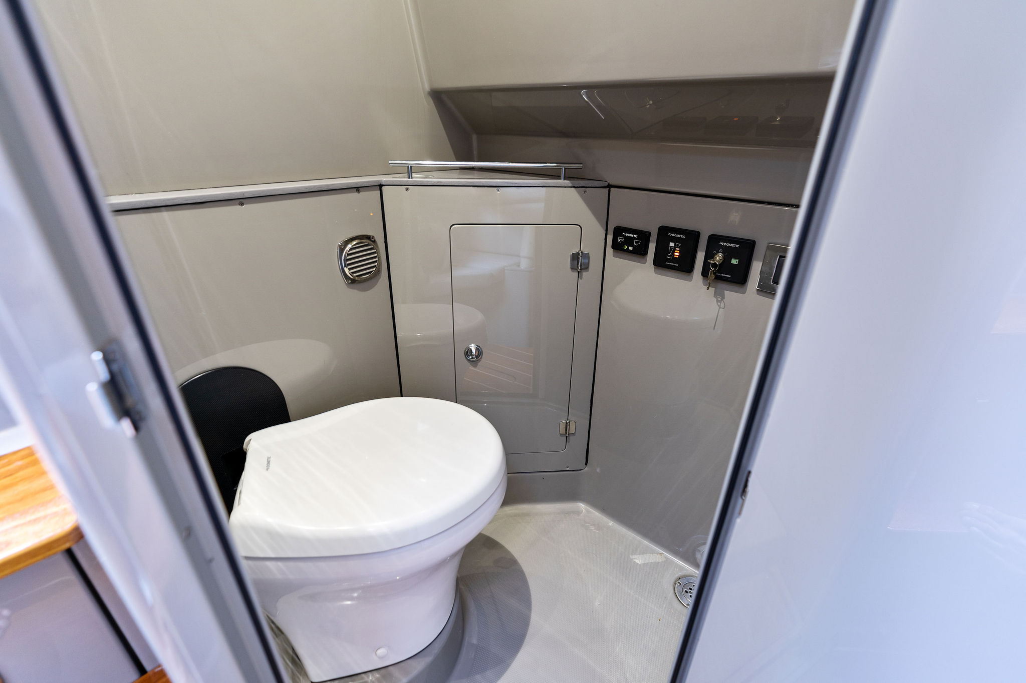Modern bathroom interior on 2023 HCB 42 Lujo boat, featuring sleek design and controls.