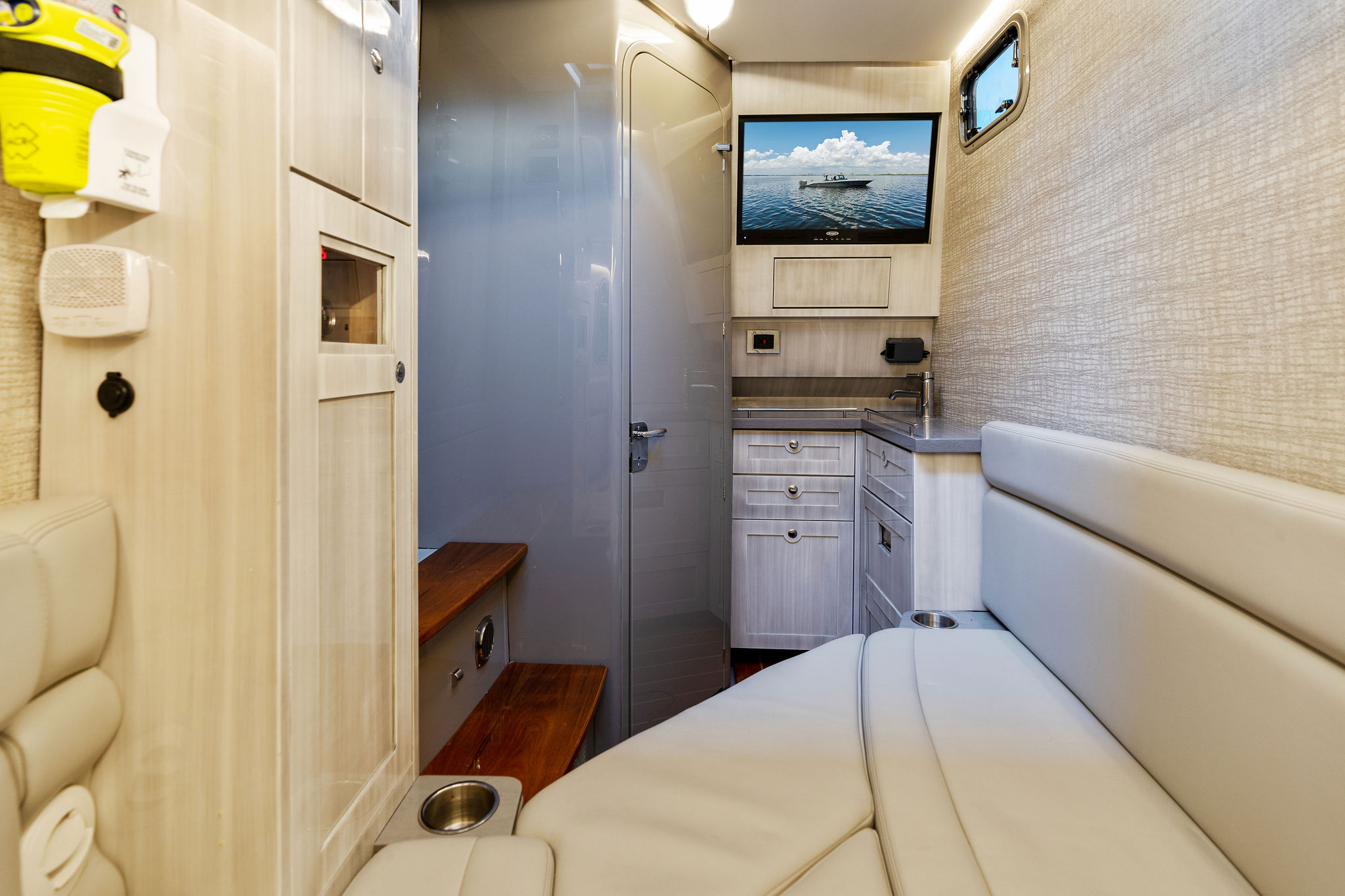 Interior of 2023 HCB 42 Lujo boat with modern seating and cabinetry.