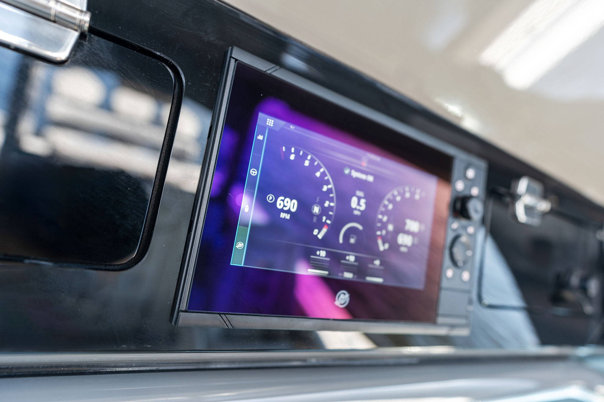 Dashboard of 2023 HCB 42 Lujo boat displaying digital gauges and controls.