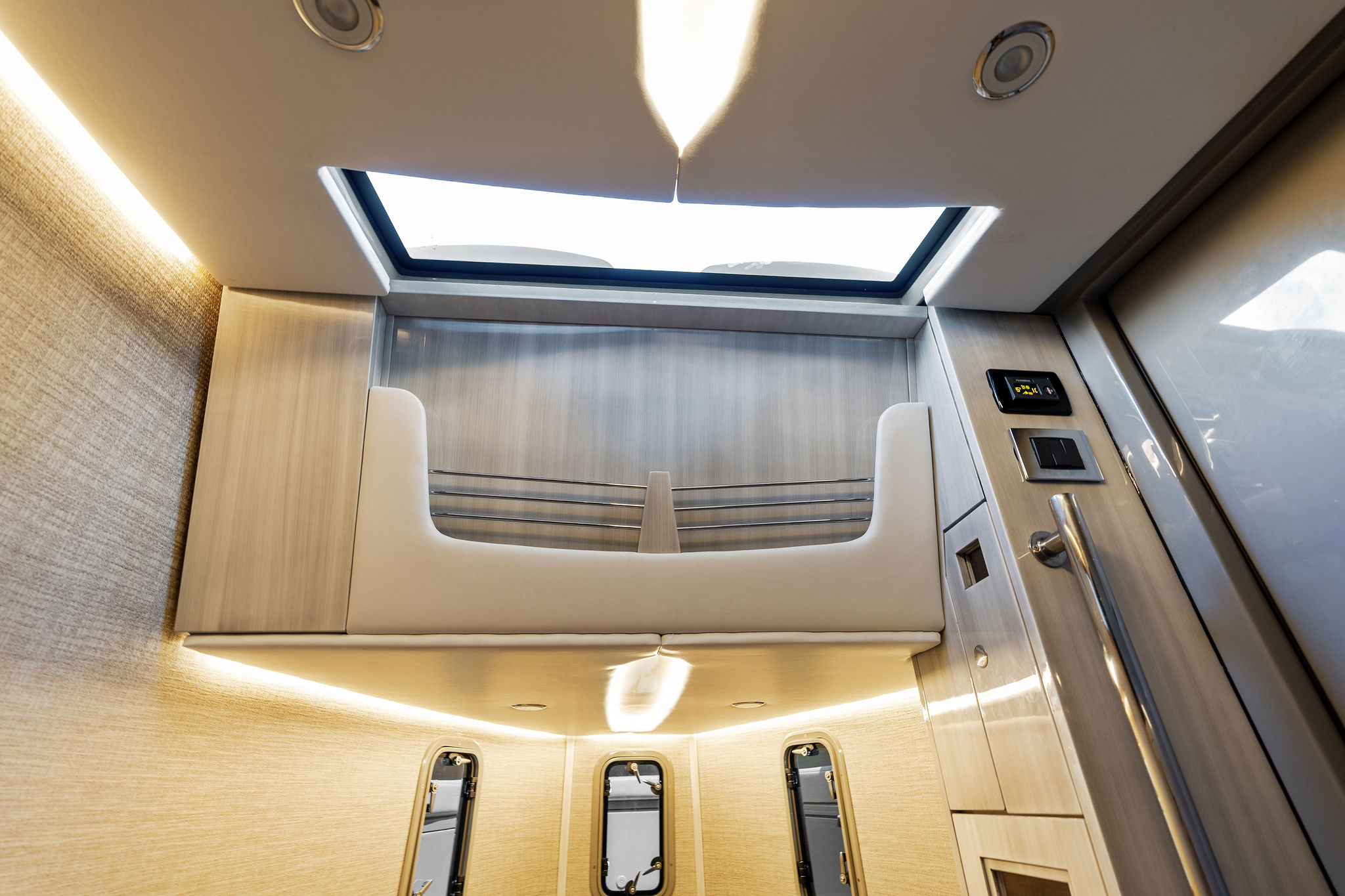 Luxurious interior of 2023 HCB 42 Lujo boat with modern design and skylight.
