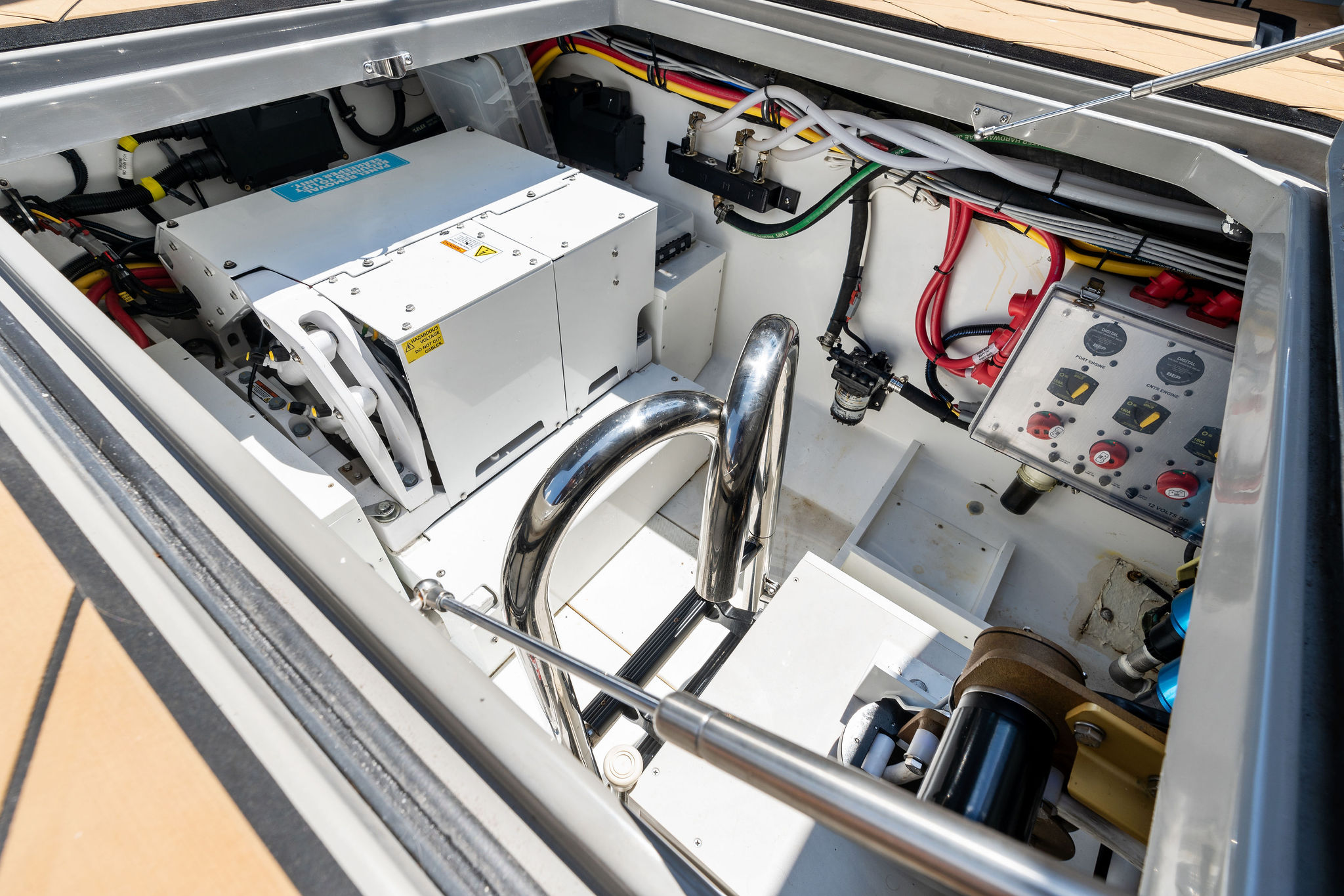 Engine compartment of 2023 HCB 42 Lujo boat, showcasing wiring and mechanical components.