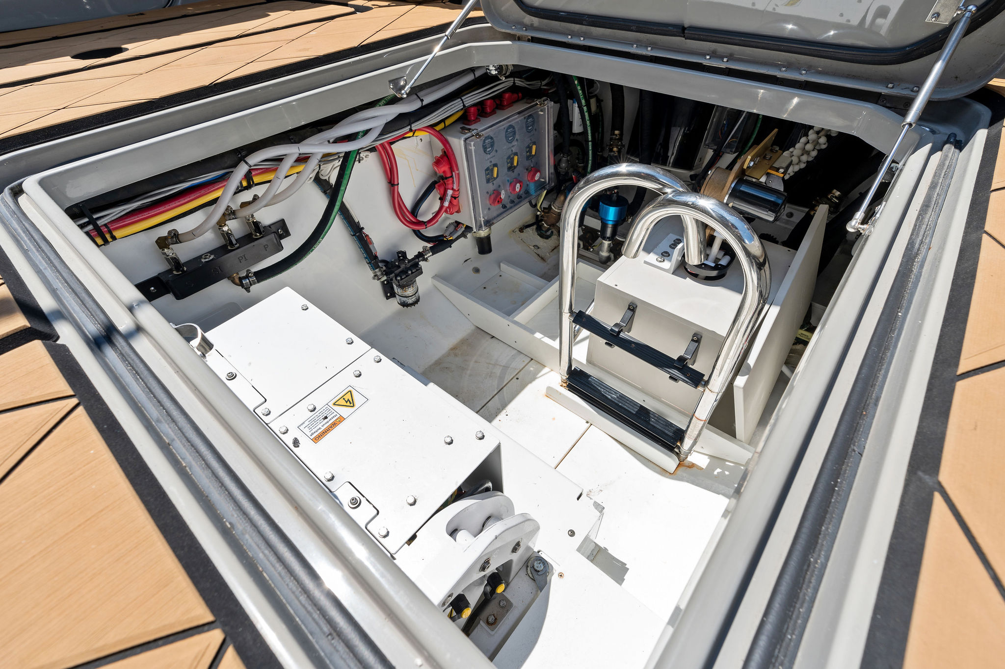 Engine compartment of 2023 HCB 42 Lujo boat, showcasing wiring and mechanical components.