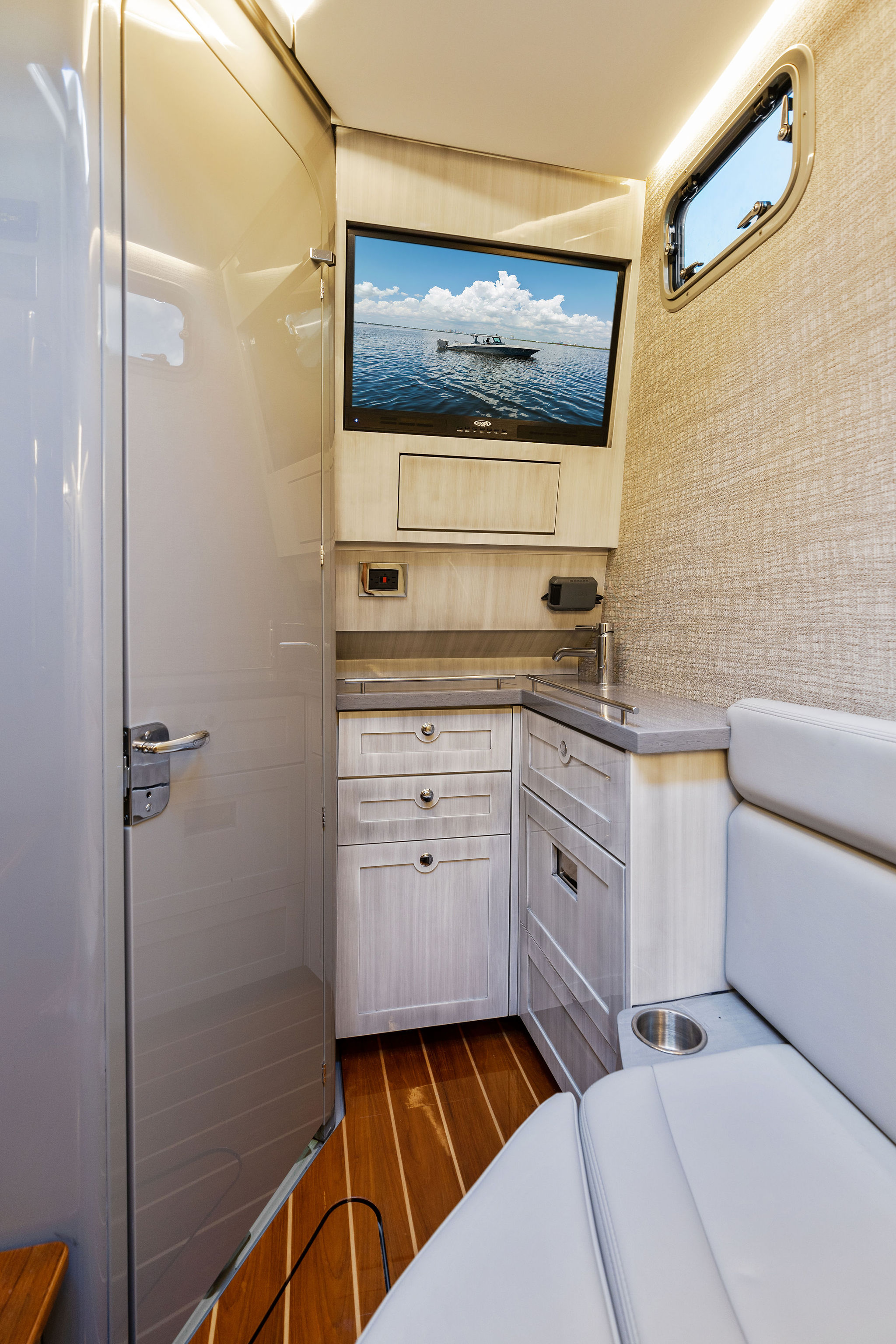 Interior of 2023 HCB 42 Lujo boat with modern cabinetry and seating.