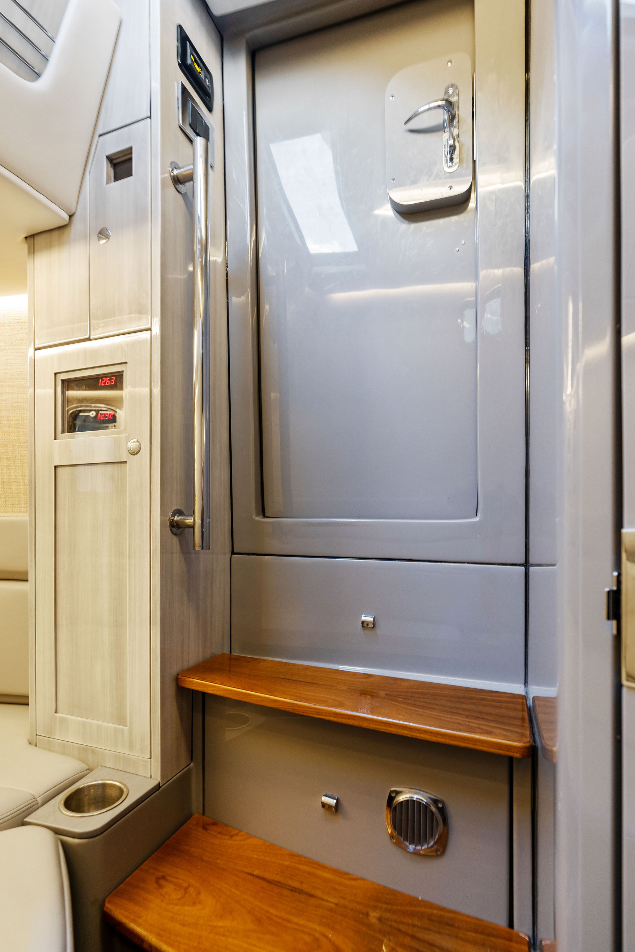 Interior of 2023 HCB 42 Lujo boat featuring sleek design and wooden steps.