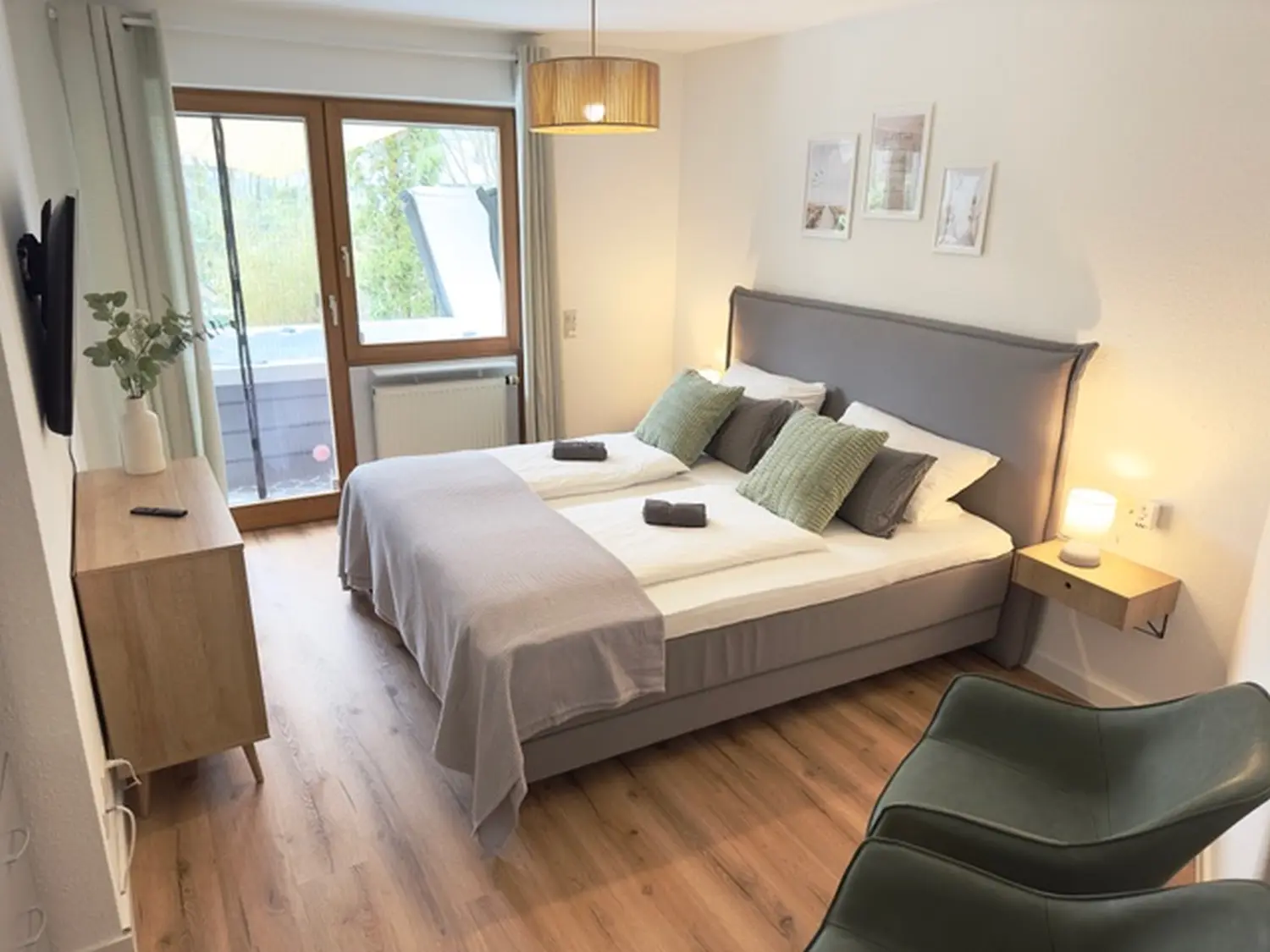 Schlafzimmer mit einem Bett und einem Fernseher, ideal für einen Luxusurlaub in Uhldingen Mühlhofen am Bodensee.