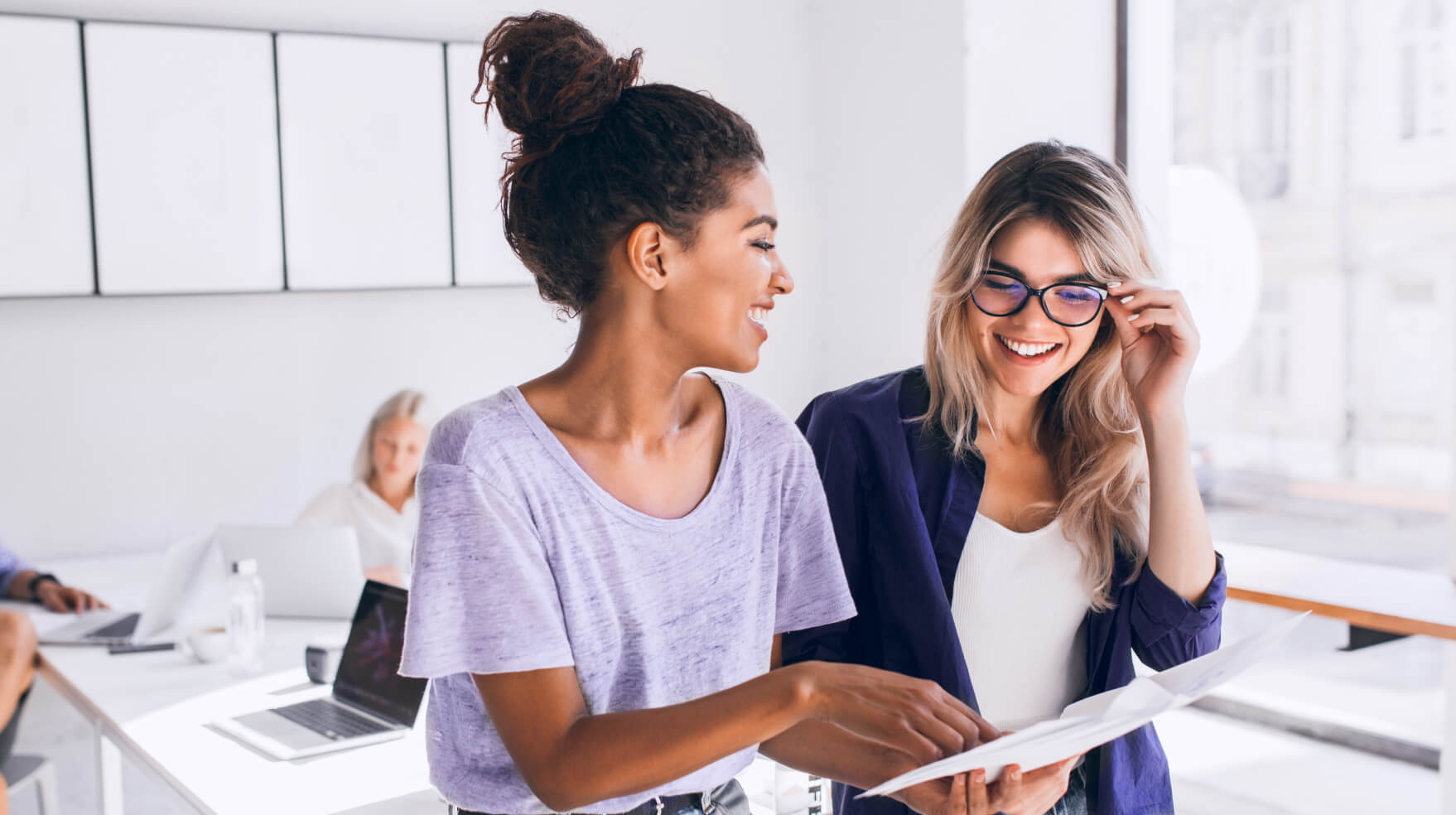 Two woman having a casual conversation about a document