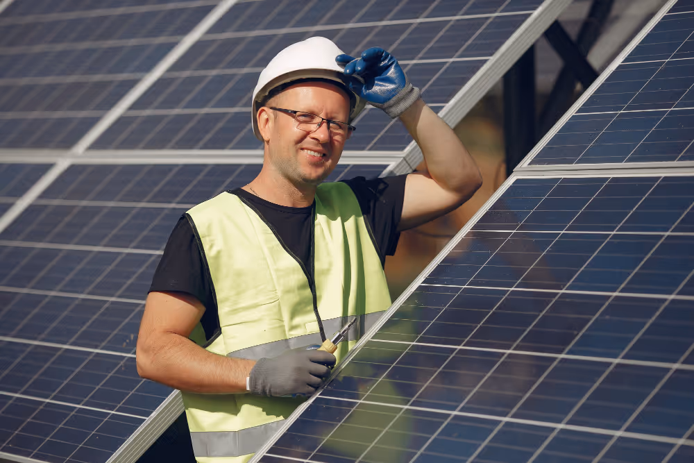 An engineer next to a solar panel