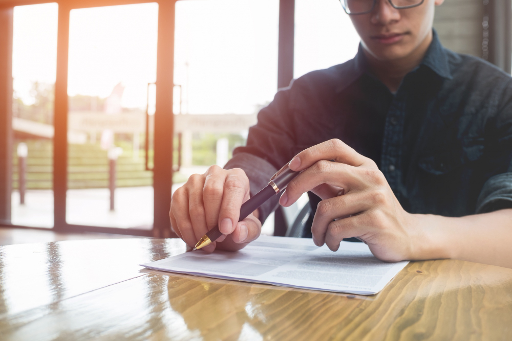 A man in glasses filling up his permit forms