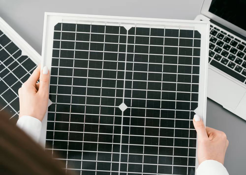 A woman holding a solar panel