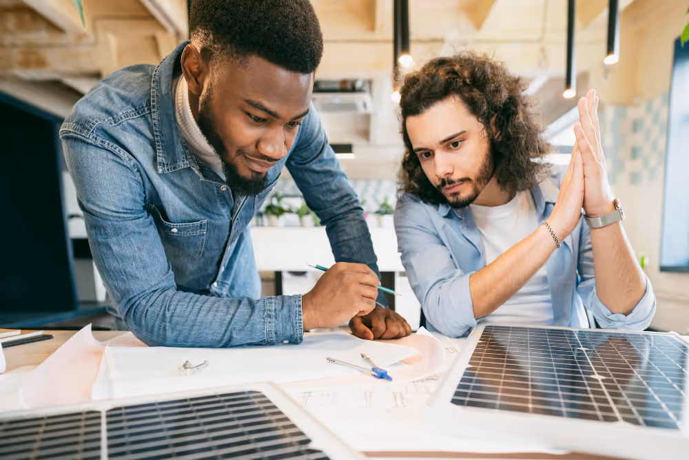 Two men in denim talking about solar panels