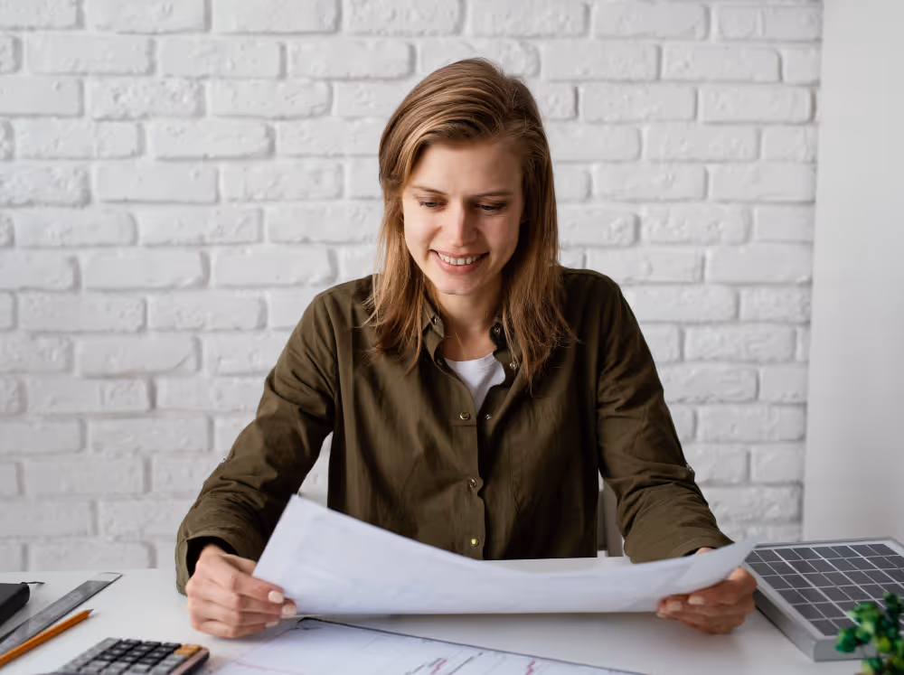 A woman on the table reviewing plans