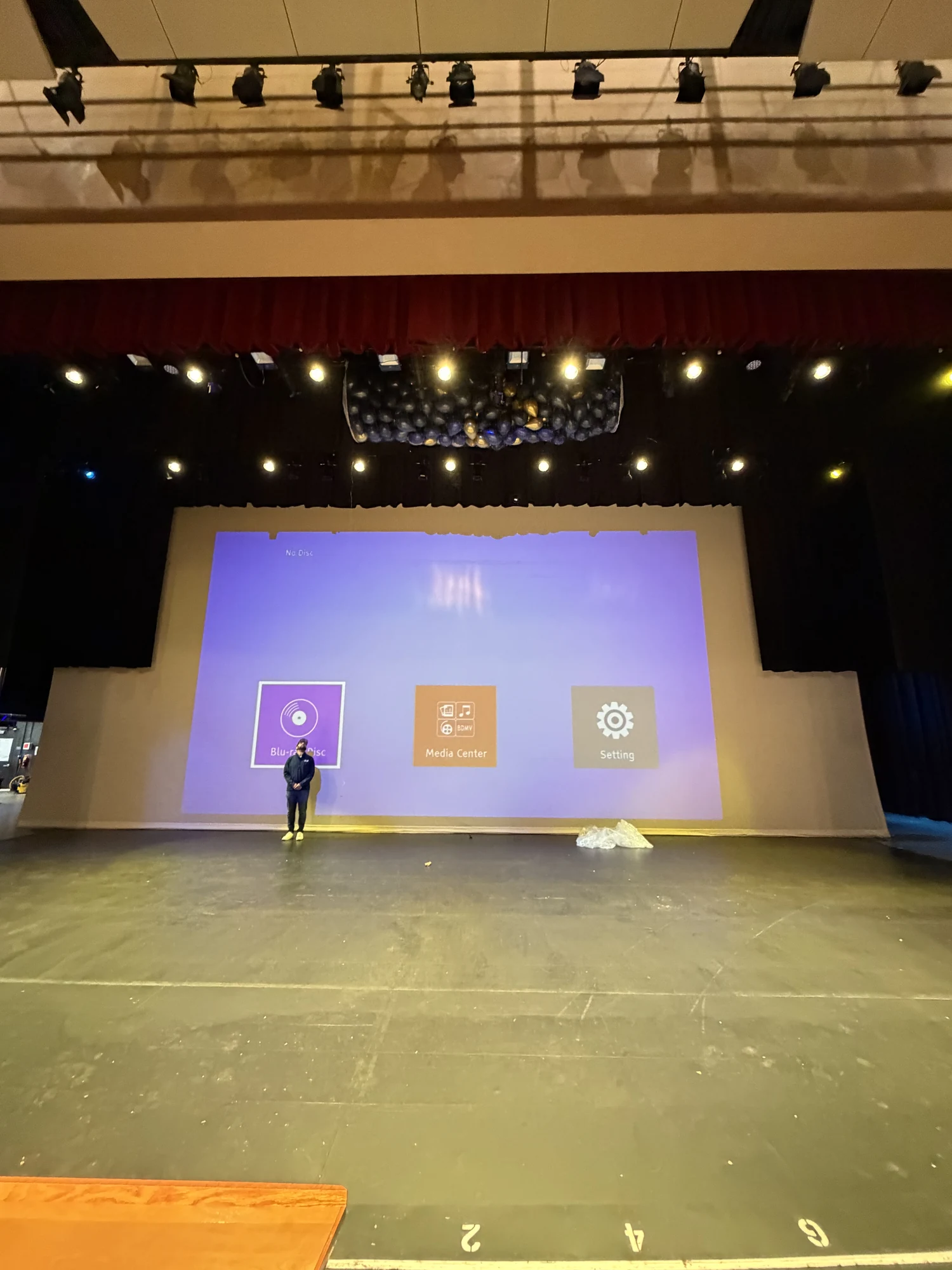 Balloon drop net suspended above an auditorium stage